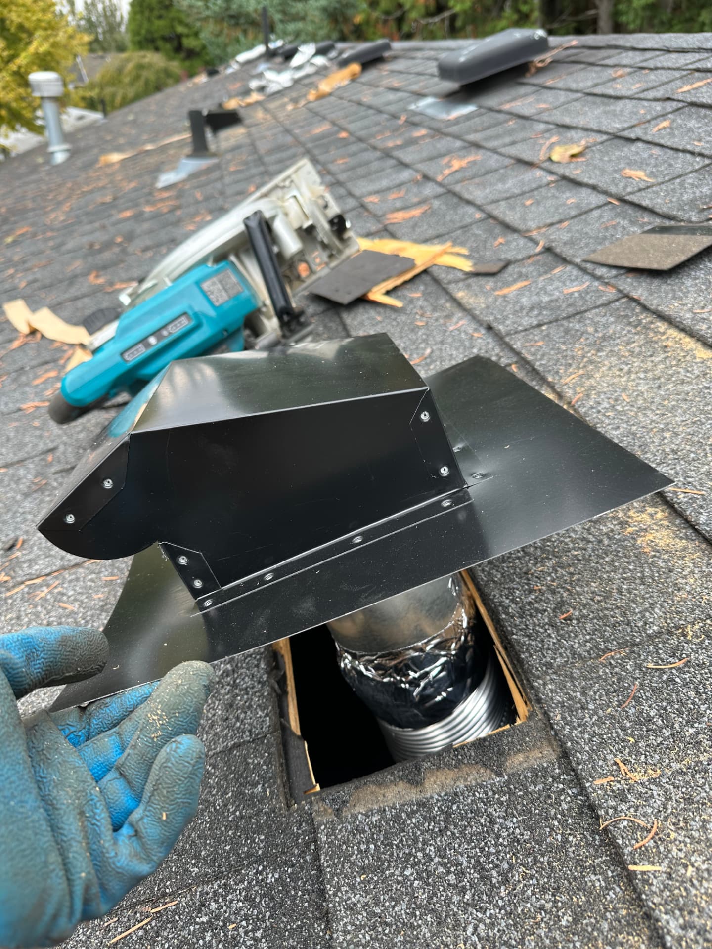 New roof vent installed and flashed over a roof duct opening